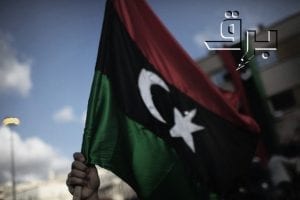 A Libyan anti-Kadhafi protester waves his old national flag during a demonstration in the eastern port city of Benghazi on February 26, 2011 as the country witnesses political turmoil and an insurrection against Moamer Kadhafi's crumbling regime. AFP PHOTO/MARCO LONGARI (Photo credit should read MARCO LONGARI/AFP/Getty Images)